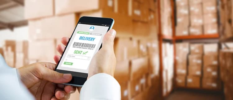 Warehouse worker using smartphone to access WMS delivery tracking system