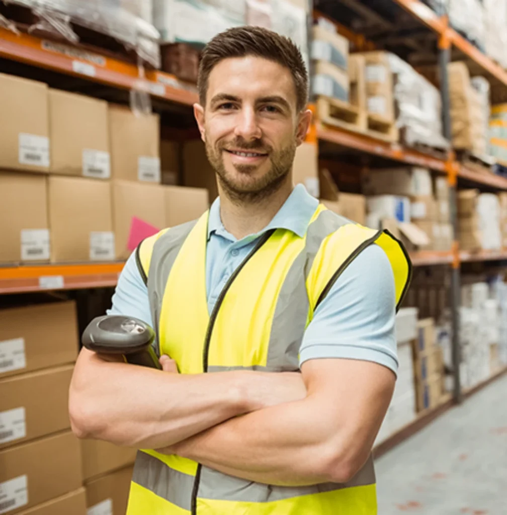 warehouse worker smiling, crossed arms, holding a scanner