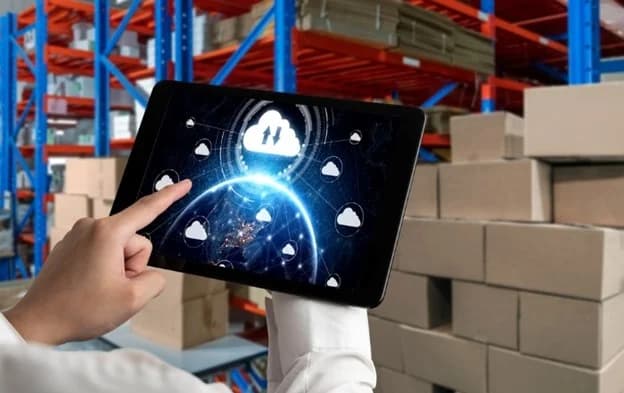 Warehouse worker using tablet with cloud WMS integration icons for 3PL eCommerce management